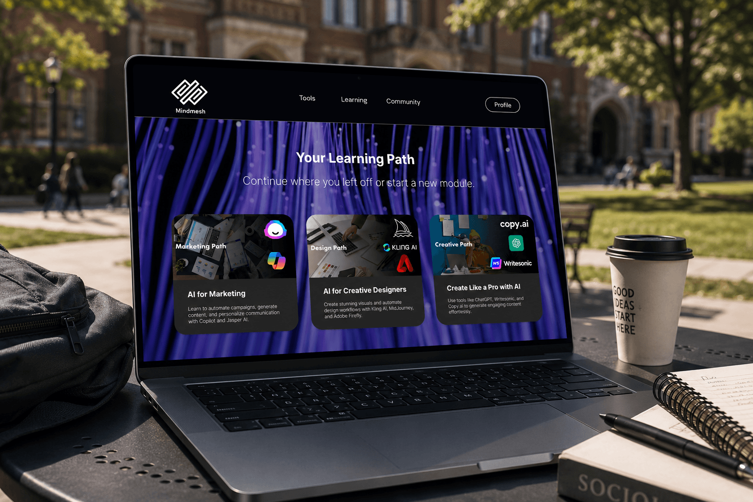 MindMesh learning path screen on a MacBook Pro in a campus setting, showing Your Learning Path with three path cards: Marketing Path, Design Path, and Creative Path with Kling AI and copy.ai logos visible.