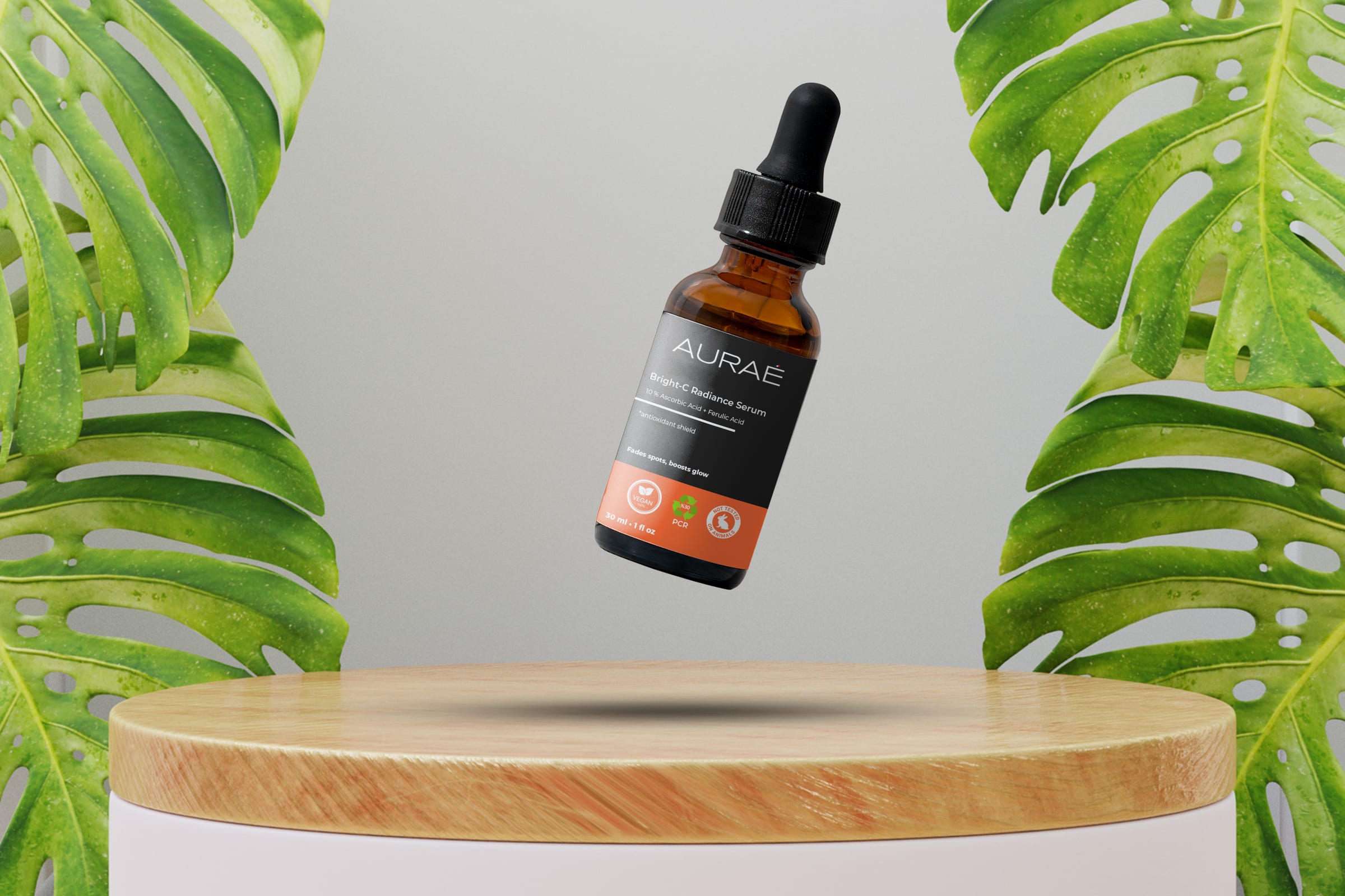 AURAÉ Bright-C Radiance Serum bottle floating between monstera leaves in a lifestyle mockup.