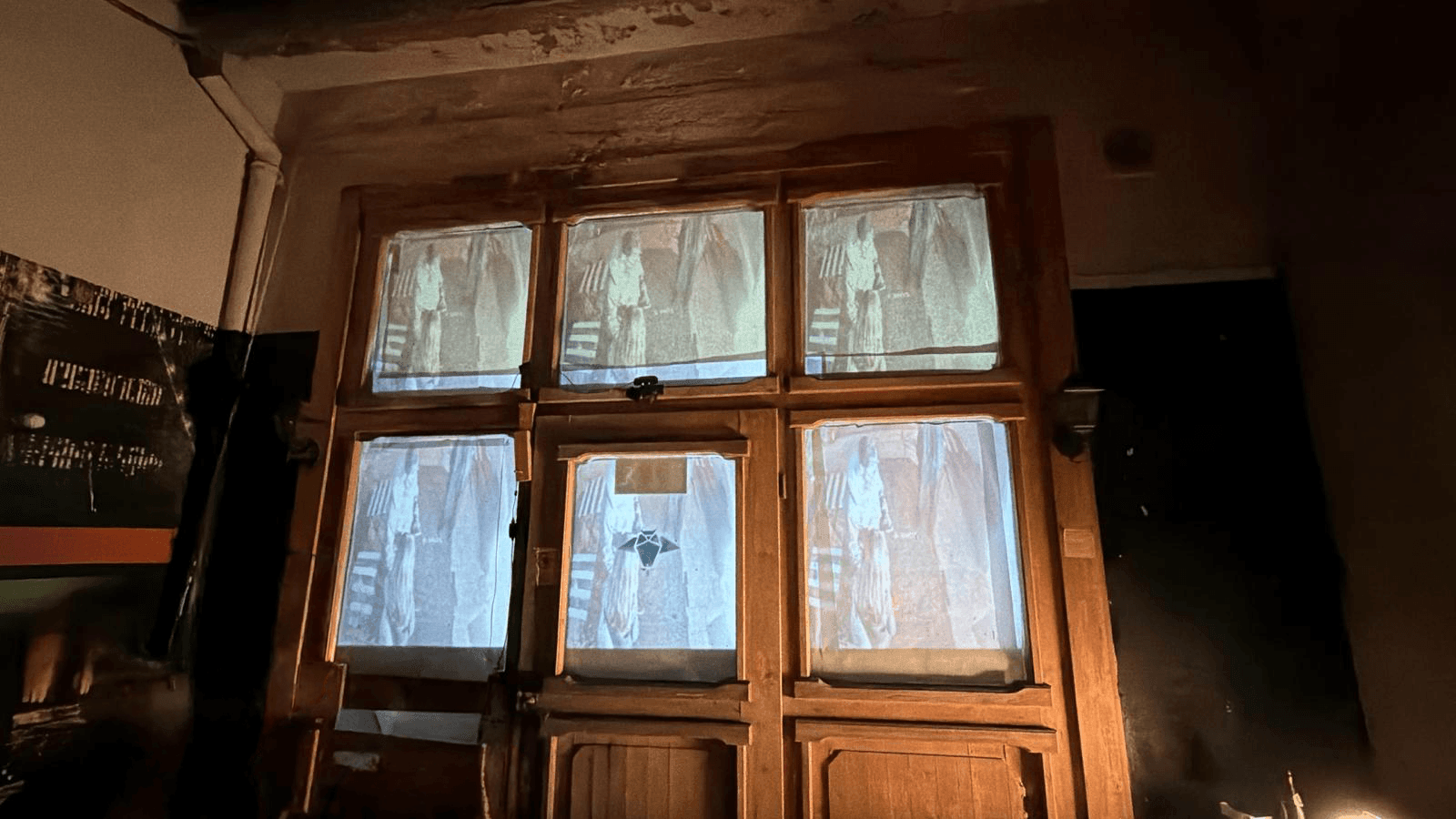 The six window panes showing grainy, desaturated captures of standing human figures, distorted by the Processing effect.