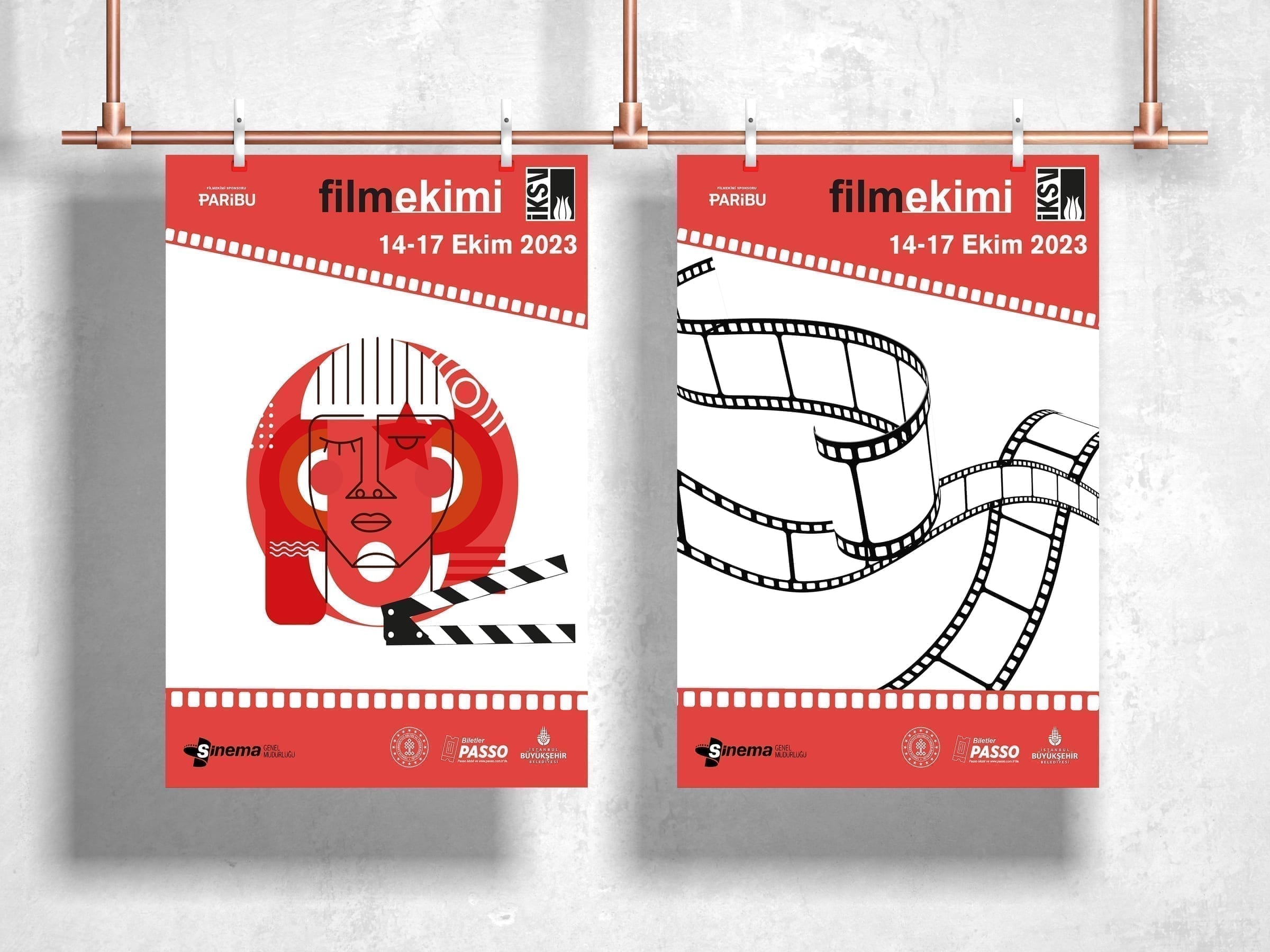 Two posters hanging from string in a gallery-style display.