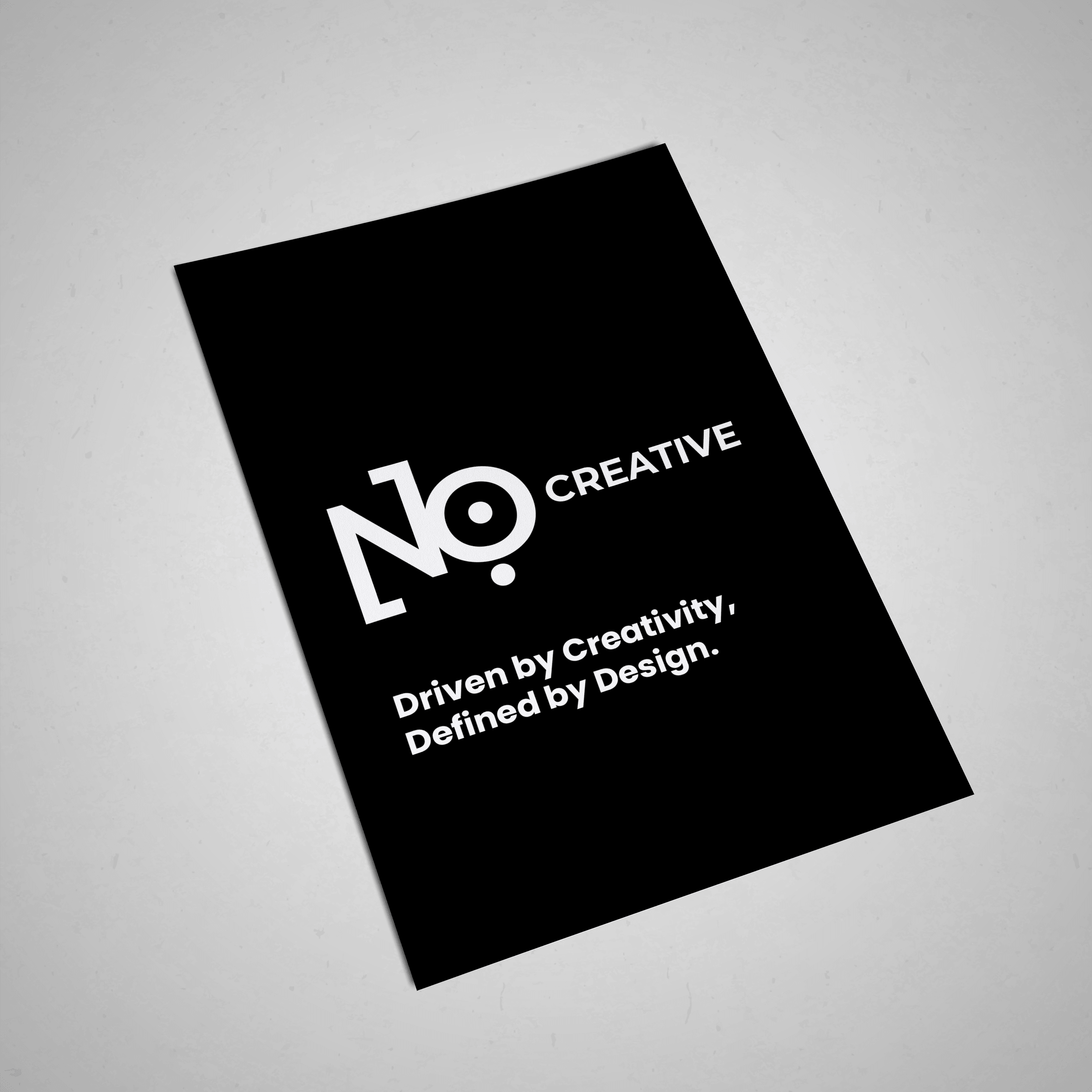 NO:118 Creative print card mockup, white logo and tagline on solid black card, slightly angled.